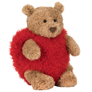 The Jellycat Bartholomew Bear 'Heartthrob' features brown fur, round ears, and sits upright in a red fluffy heart costume.