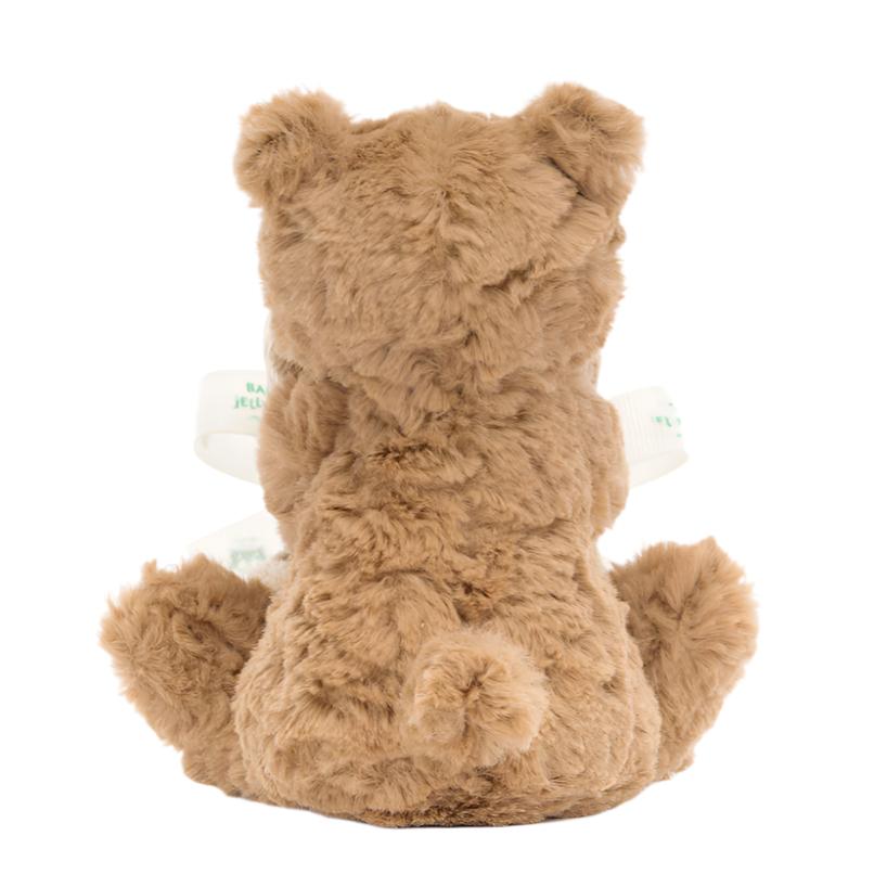 The Jellycat Bartholomew Bear Soother by Jellycat sits upright, showcasing a soft, fuzzy texture crafted from recycled fabrics with a ribbon around its neck.