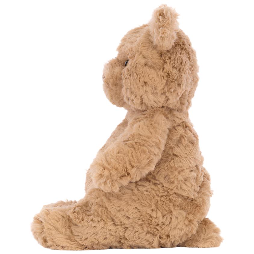 Bartholomew Bear, Tiny by Jellycat sits upright in profile, facing left, against a plain white background.