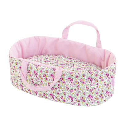 The Corolle 12" Carry Bed - Floral is a delightful pink baby basket with a floral pattern, complete with handles and a soft pillow, ideal for carrying your Corolle baby doll.