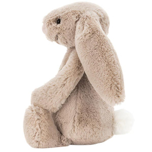 The Jellycat Bashful Beige Bunny, Small, is a plush light brown bunny with long floppy ears, black eyes, a pink nose, and a white fluffy tail—an adorable gift for any occasion.
