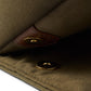 Close-up of the Bennett Winch S.C Holdall, designed with khaki waterproof canvas, a magnetic button closure, and leather trim detail.