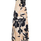 The Cara Cara Benita Dress is a strapless, ankle-length fit-and-flare gown in stretch crepe with a beige base and bold black floral print, shown on a plain white background.