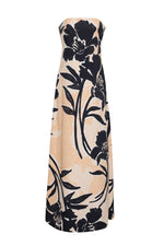 The Benita Dress by Cara Cara is a strapless, beige stretch crepe gown with a placed black floral print and an elegant A-line silhouette.