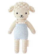 Benjamin the Lamb - Little 13" by Cuddle + Kind is a charming plush toy with cream-colored wool, black eyes, and a blue romper, shown on a white background—a perfect gift for kids.