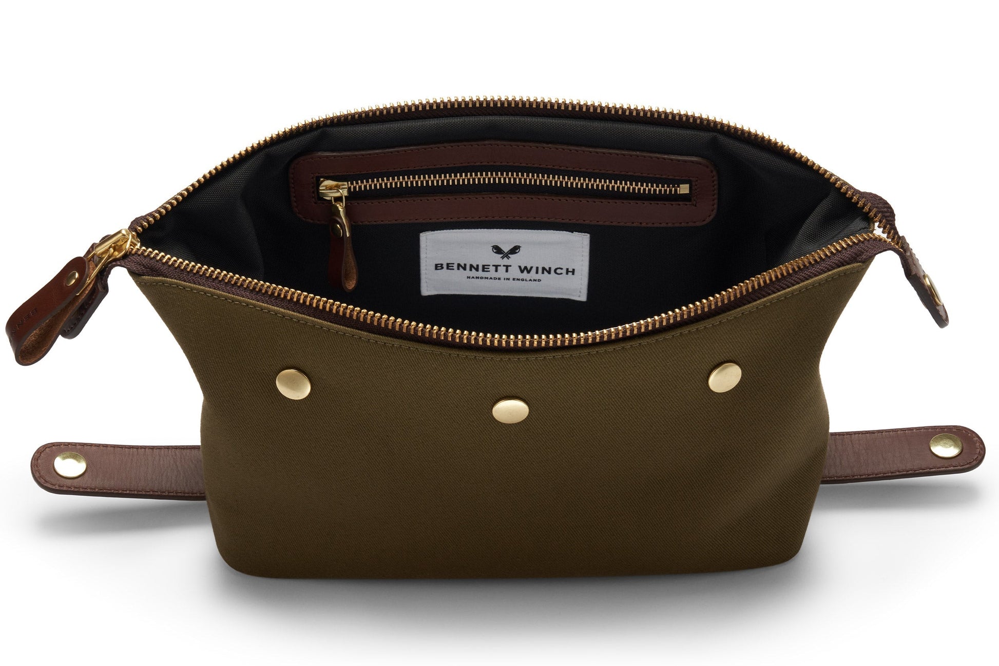 Bennett Winch Canvas Wash Bag in open green canvas features brown leather accents, a YKK brass zipper, gold snaps, and an interior label with the "Bennett Winch" brand.