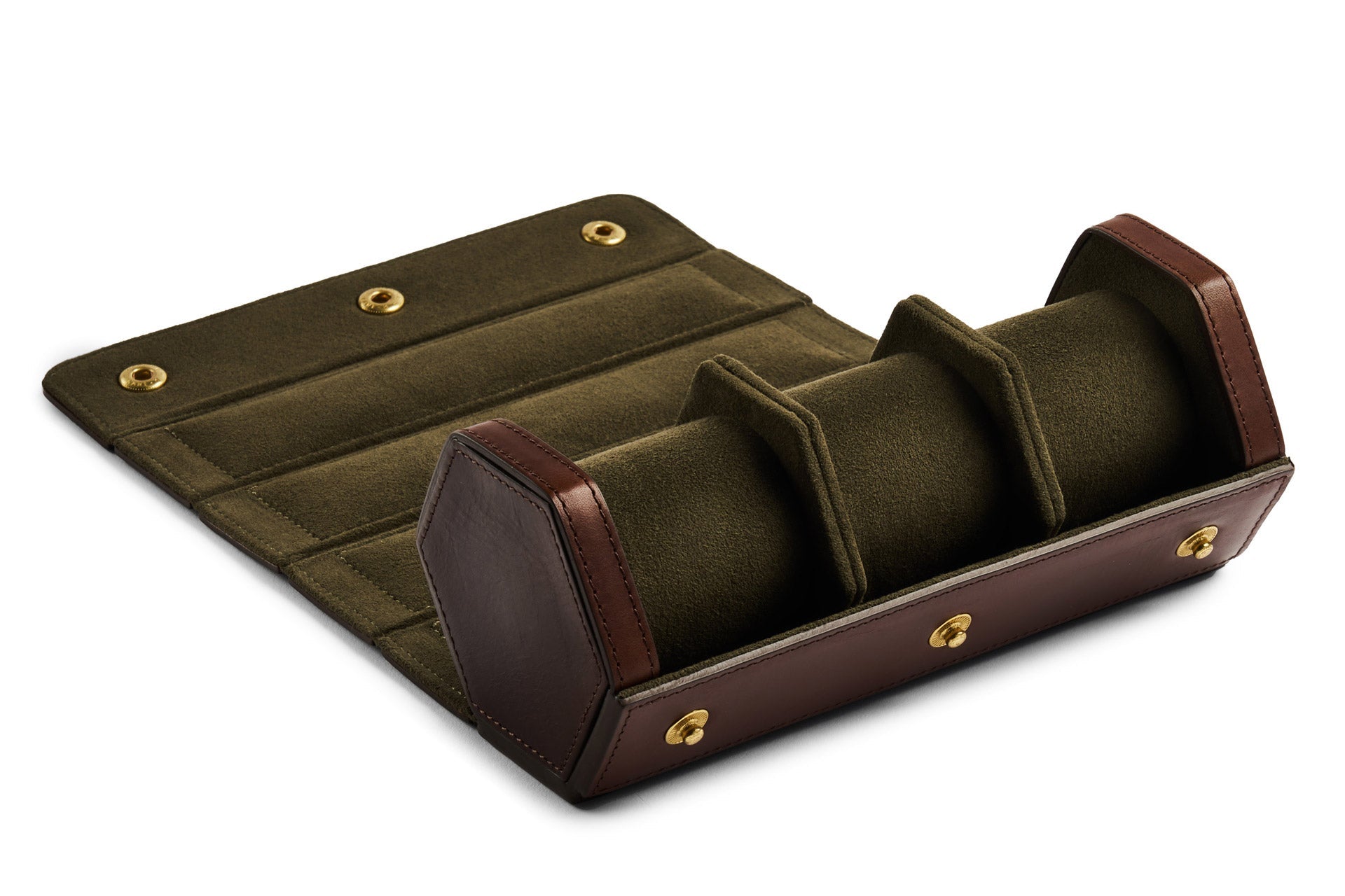 The Bennett Winch Triple Watch Roll, a blend of olive green fabric and brown Tuscan leather panels, is handmade in London. Designed with three compartments and brass snap closures, it opens to lie flat for easy access.