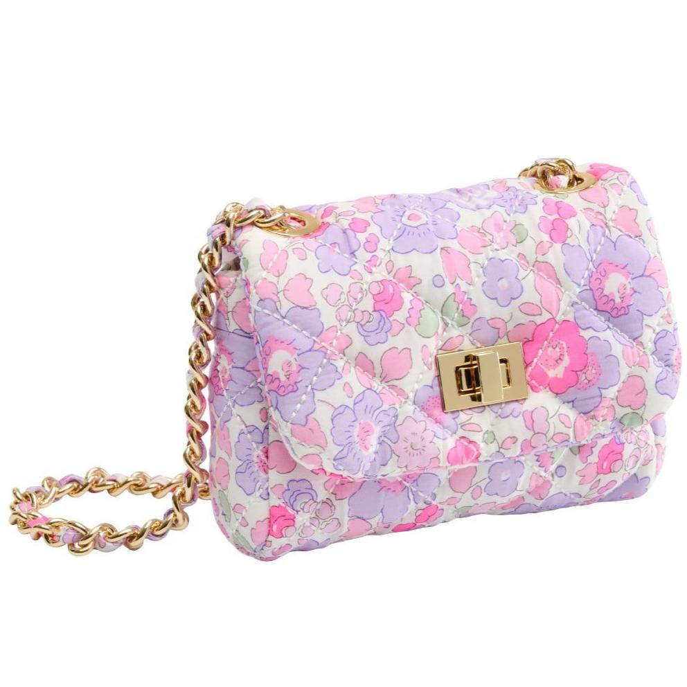 The Milledeux® Small Chain Bag – Liberty Fabric Betsy F / Neon is a hand-made handbag featuring a floral-patterned design crafted with Liberty of London fabric. It comes with a quilted flap adorned with a gold chain strap and is completed with an elegant gold clasp.