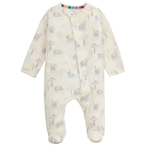 The Magnetic Me Baby Modal Footie is a cream, long-sleeve onesie made from eco-friendly TENCEL™ modal, featuring a subtle animal and tree print, snap buttons, and covered feet.
