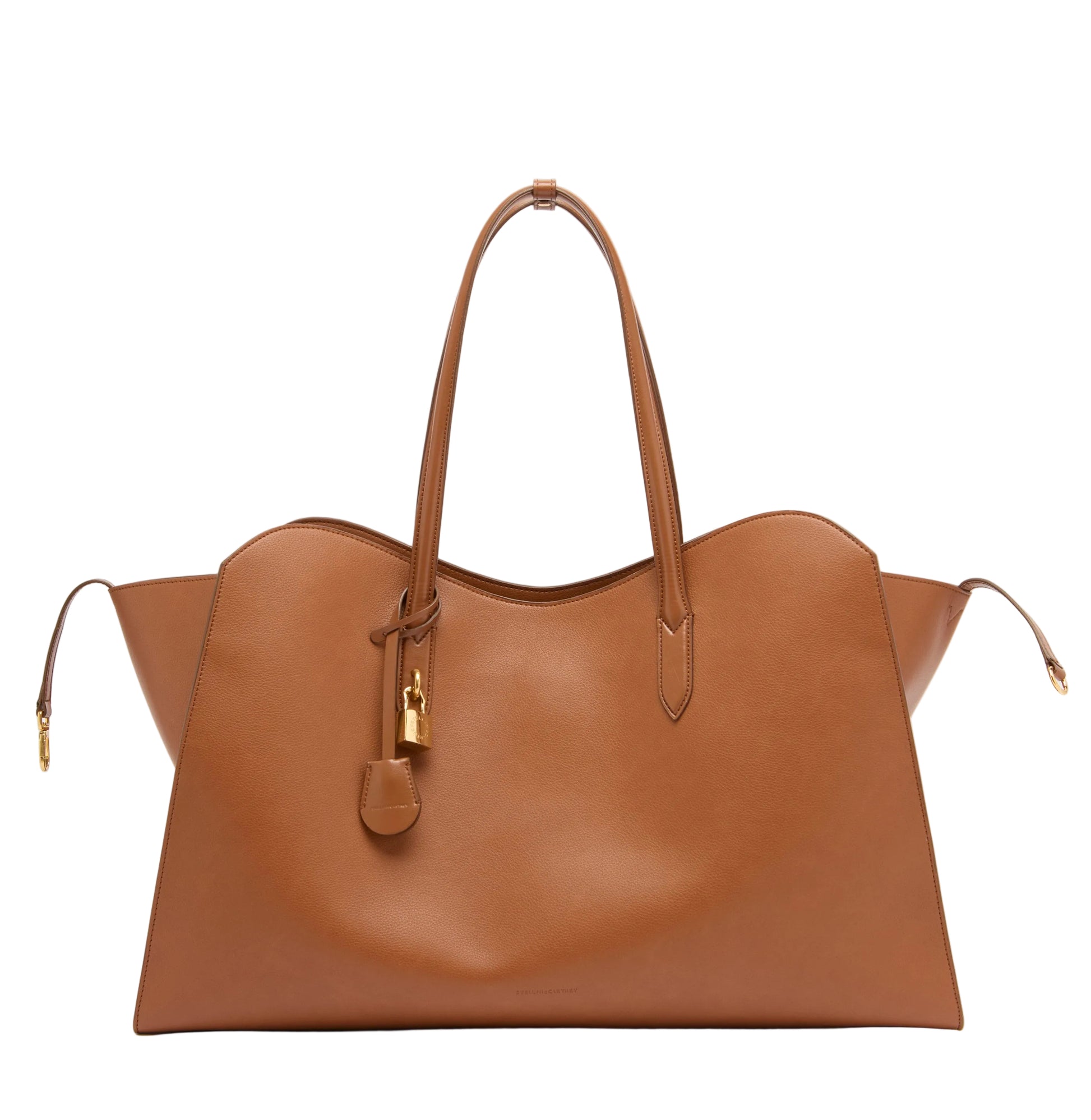 The Stella McCartney Stella Ryder Weekender Bag is a large brown Italian handcrafted tote featuring two handles, distinctive side wing details, a hanging padlock, and elegant gold hardware, displayed against a plain white background—making it the ideal travel companion for your next adventure.