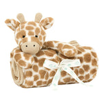 A Jellycat Giraffe Blankie from the Jellycat brand is wrapped around a rolled, brown-spotted blanket tied with a bow and made from recycled fibers.