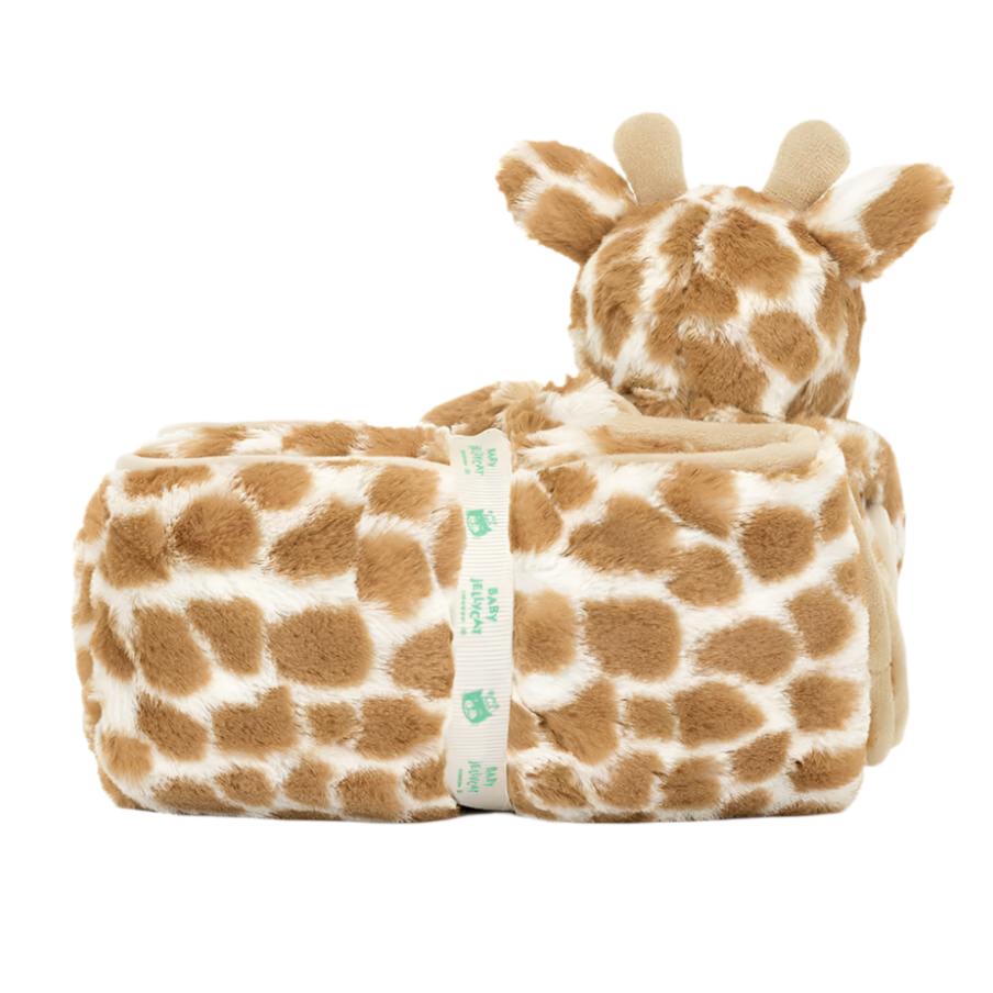 A Jellycat Giraffe Blankie is displayed next to a rolled-up blanket with a matching giraffe pattern, held together with a Baby Jellycat grosgrain ribbon. Made from recycled fibers, it offers both cuddliness and eco-friendliness.