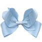 The Milledeux® Jumbo Boutique Bow in Bluebell, made from OEKO-TEX® materials, features a textured light blue ribbon and is attached to a grosgrain-covered alligator clip.