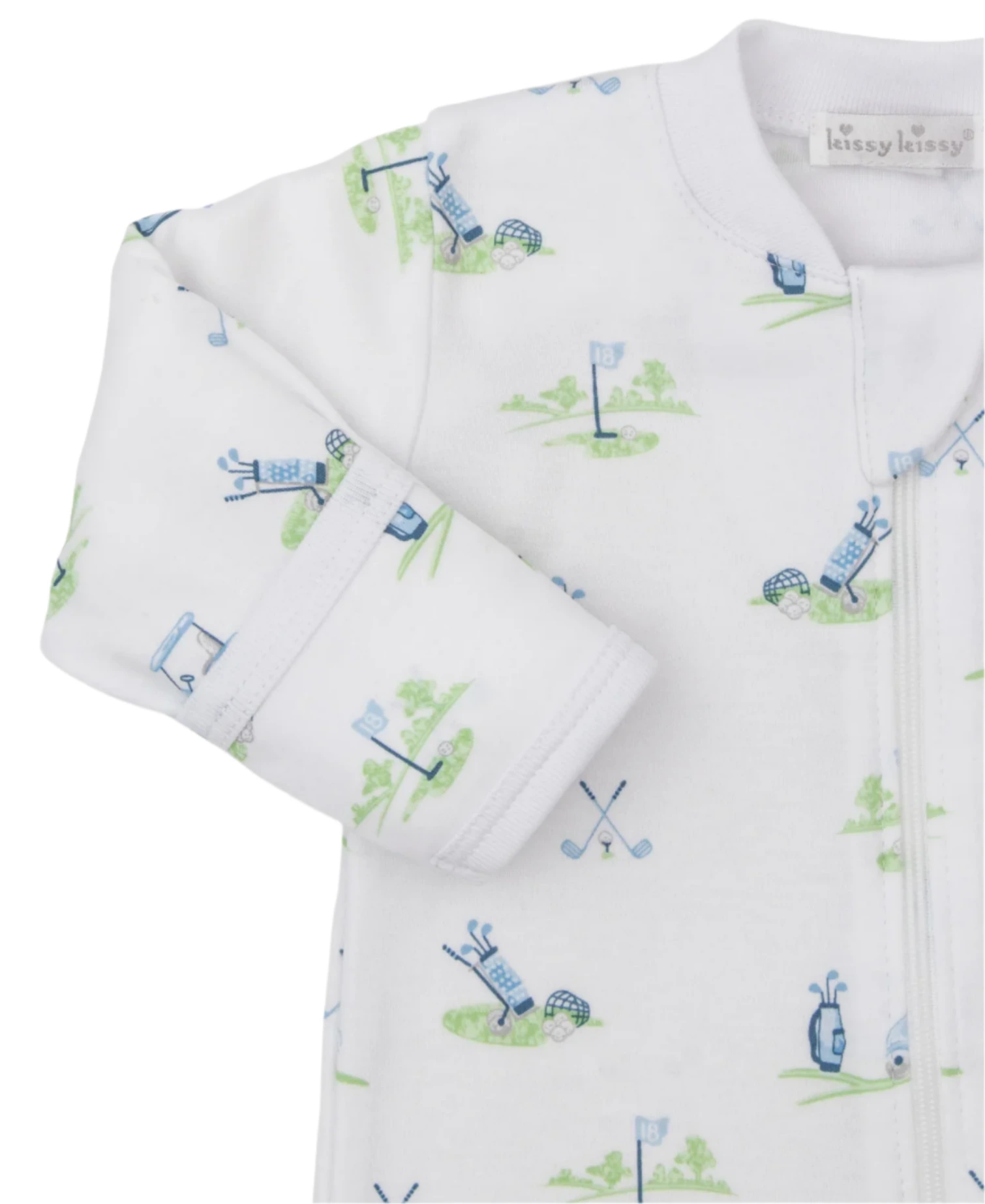 The Kissy Kissy Fairway Foursome Printed Zip Footie is a white baby onesie made from soft Pima cotton, featuring a charming golf-themed print with golf bags, flags, and crossed clubs in blue and green.