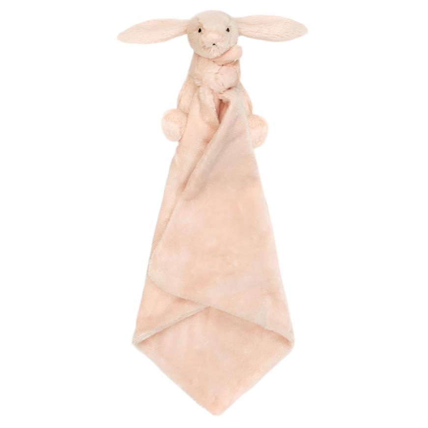 The Jellycat Bashful Blush Bunny Soother is a plush toy blanket in a soft, pinkish-beige hue, crafted from recycled fibers and designed with the head and arms of a Bashful Pink Bunny at the top.