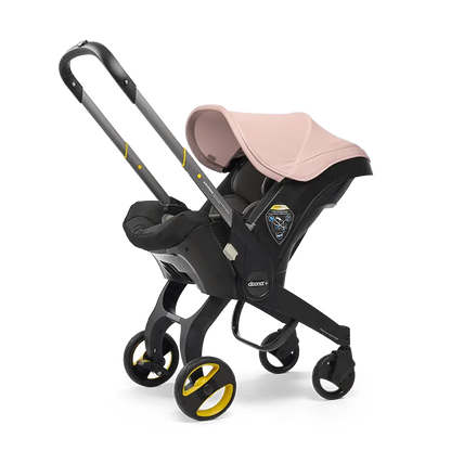 The Doona Car Seat and Stroller by Doona is a stylish black and pink travel system that combines a car seat mounted on a four-wheel frame with an easy-to-use handlebar, providing an ideal mix of style and functionality.