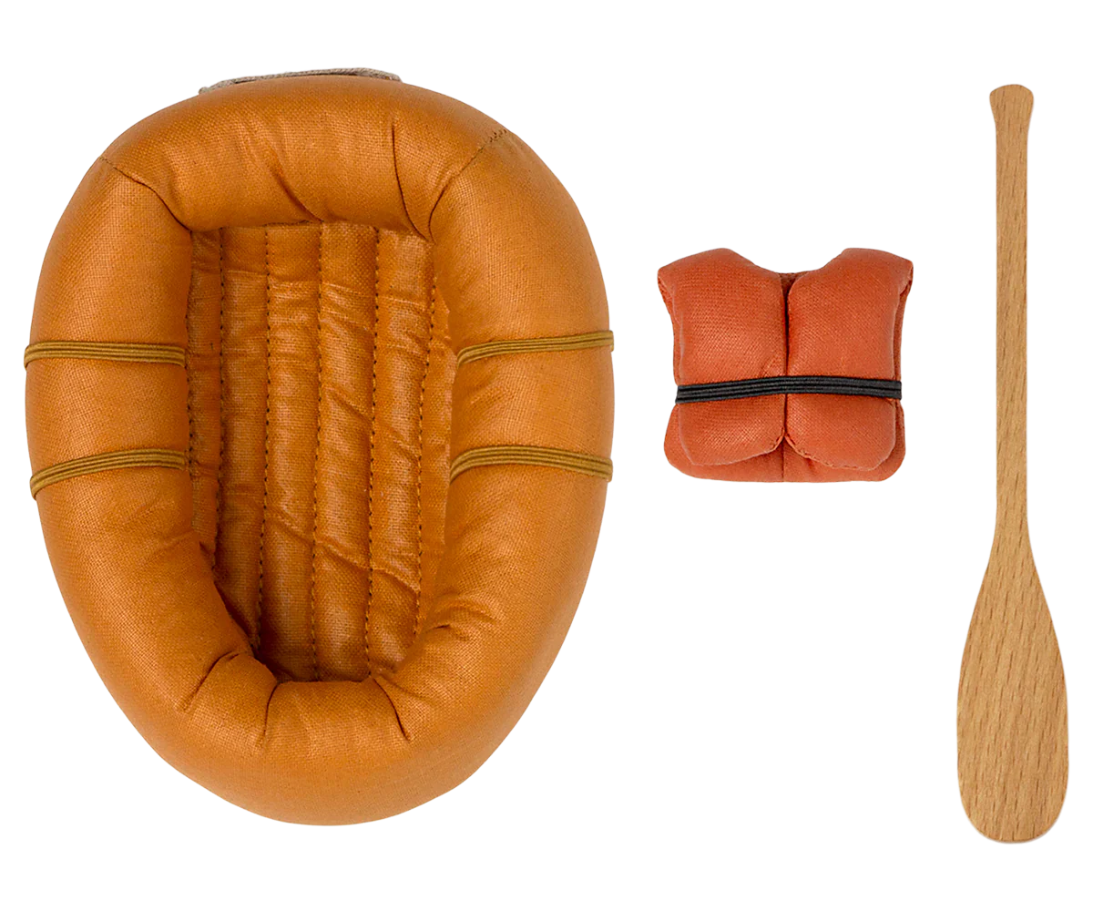 A miniature set perfect for a pretend water adventure, featuring a dusty yellow rubber boat from Maileg, an orange life vest, and a wooden oar, all arranged against a white background.