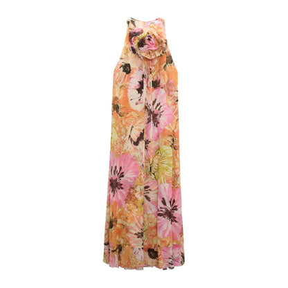 The Floral Dream Dress by Dorothee Schumacher is a sleeveless viscose georgette dress featuring a bold pink and orange floral print, high neckline, and a fabric flower detail at the collar.