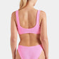 A woman with blonde hair in a ponytail is seen from behind wearing the textured retro Hunza G Bonnie Bikini with high waist briefs, set against a plain white background.