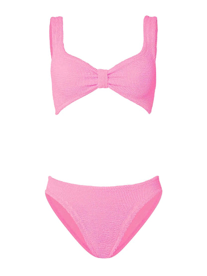 The Hunza G Bonnie Bikini is a two-piece pink, textured retro set with a supportive knotted front top and high-waist briefs, shown on a white background.