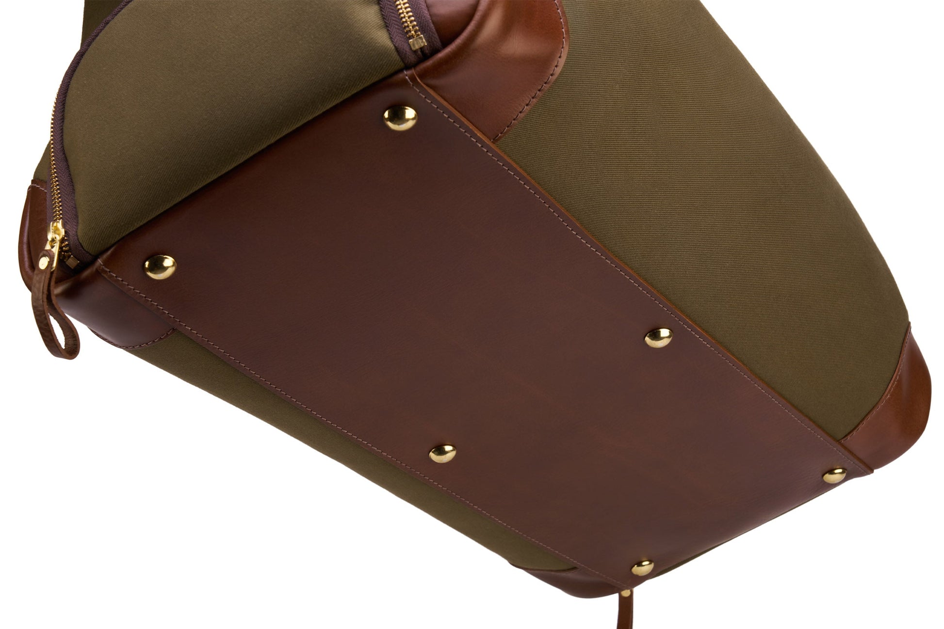 Close-up of a green Bennett Winch Canvas Weekender, expertly crafted from waterproof canvas with brown full grain leather accents and gold studs on the bottom.