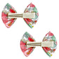 The Milledeux® Small Bowtie Bow Liberty Betsy Q set includes two bows arranged side by side, each featuring a vibrant floral pattern in red, pink, and green. These bows are crafted from Liberty of London fabric and come with nickel-free hair clips on the back to ensure a comfortable and secure hold.