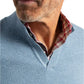 Close-up of a man wearing the Johnnie-O Estaban Quarter Slit Sweater with its textures and layers enhancing his casual yet classic look, reminiscent of Steve McQueen's timeless style.