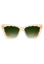 The Brigitte Sunglasses by Krewe are beige cat-eye frames in lightweight acetate, featuring scalloped green gradient lenses, shown front-facing on a white background.
