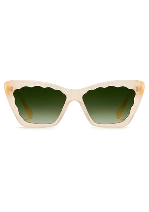 The Brigitte Sunglasses by Krewe are beige cat-eye frames in lightweight acetate, featuring scalloped green gradient lenses, shown front-facing on a white background.
