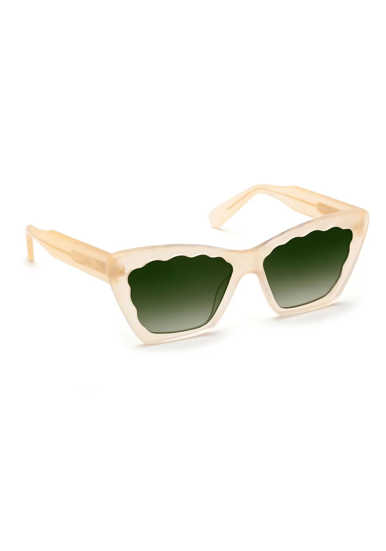 The Brigitte Sunglasses by Krewe feature a beige cat-eye frame made of lightweight acetate, green-tinted lenses, and playful scalloped edges along the wavy top, displayed against a white background.