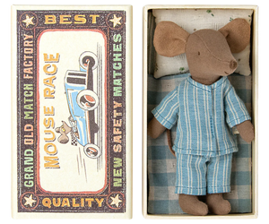 The Maileg Big Brother Mouse in Matchbox - Blue wears blue striped pajamas and rests in a cozy matchbox bed featuring vintage “Mouse Race” and “Grand Old Match Factory” designs on the lid.