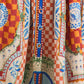 Close-up of the Eva Skirt by Hunter Bell NYC, showcasing a checkered pattern, blue buttons, and an intricate sundance tile print in red, orange, blue, and green on a soft linen-rayon blend.