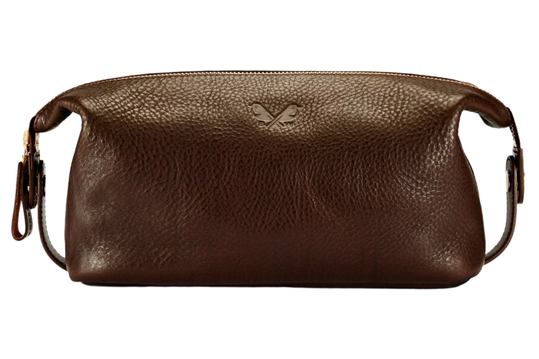 The Bennett Winch Leather Wash Bag, crafted by the Bennett Winch brand, showcases a luxury RiRi zip, side handles, and a bird emblem embossed on the front, all made from full grain Tuscan leather in a rich brown color.