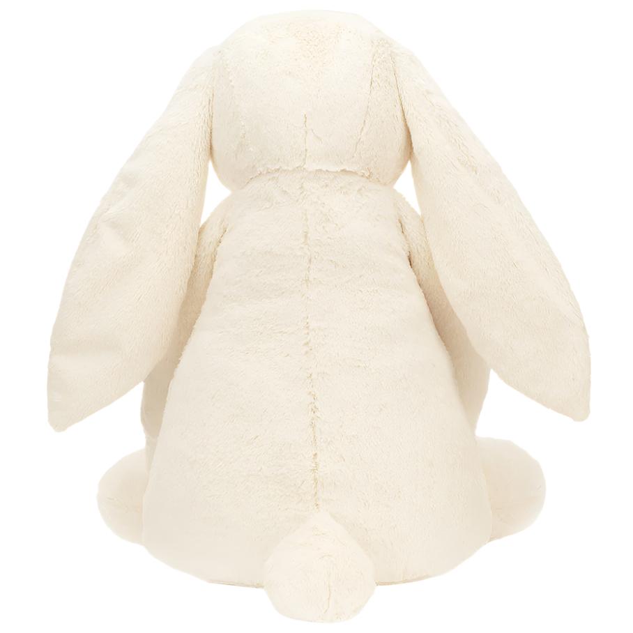 The Jellycat Bashful Cream Bunny, Giant by Jellycat, is a plush stuffed bunny with long ears and a small tail, crafted from soft polyester and featuring an adorably shy pose.