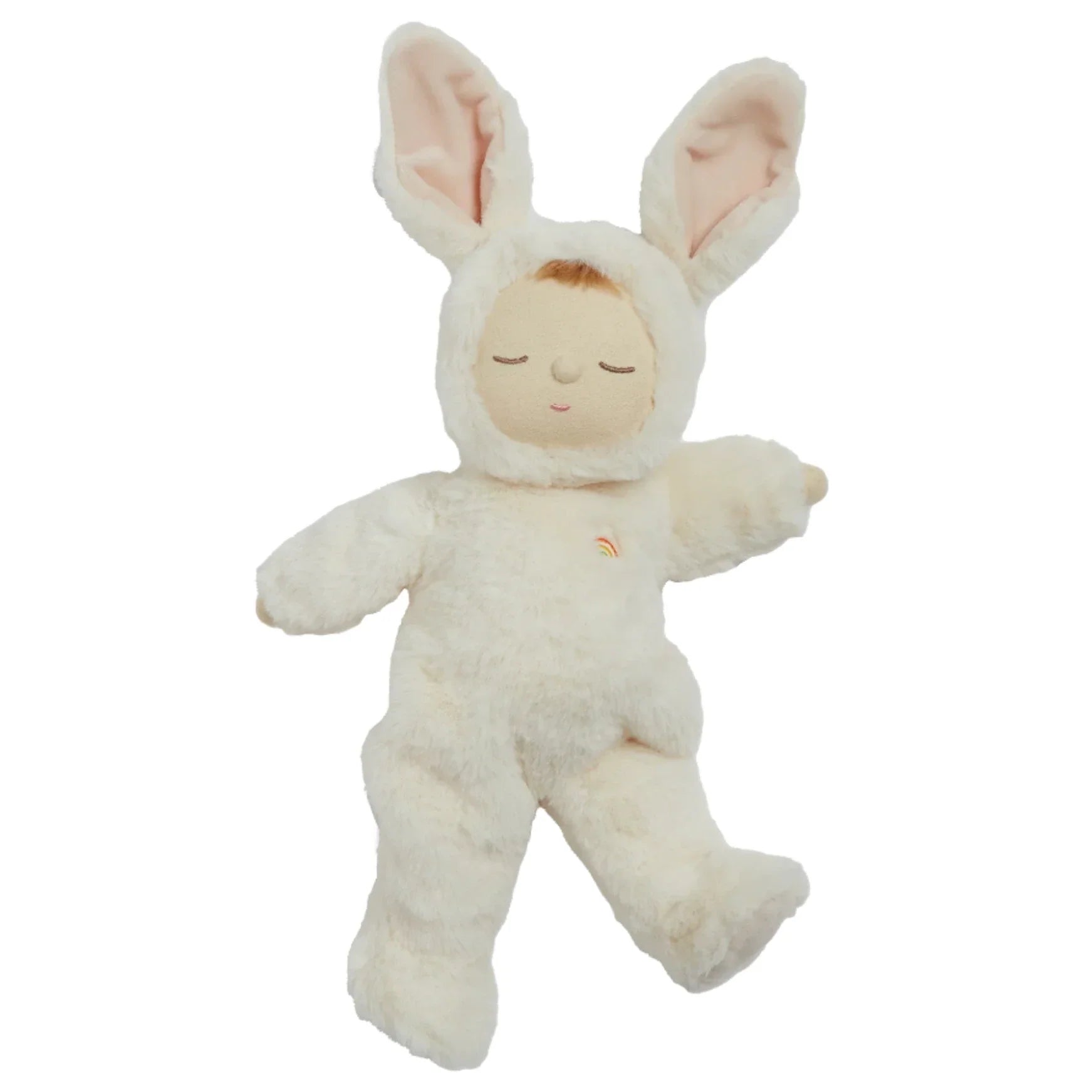 An Olli Ella Cozy Dinkum Doll dressed in an adorable white bunny costume with long ears, closed eyes, and a small rainbow emblem on the chest—a perfect posable doll for a newborn baby gift.