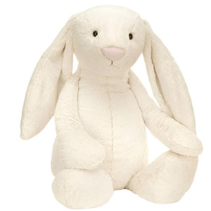 Introducing the Jellycat Bashful Cream Bunny, Giant—a plush bunny with long ears and a pink nose, sitting upright in unparalleled softness.