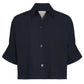 The Next Ex Shirt by TWP is a short-sleeved, dark navy button-up with a collar and chest pocket, made from vintage washed poplin in a relaxed boxy fit, showcasing three visible front buttons.