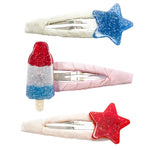 The Lillies & Roses Popsicle Rocket & Stars Red Blue Snap Clips set includes a blue glitter star, a red glitter star, and a red, white, and blue glitter popsicle—perfect for summer or Fourth of July hair accessories.