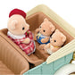 Three Calico Critters figures—a parent and two children—sit inside the Classic Family Car. The parent wears a red hat and dress, while the children are dressed in blue and white outfits, making this Classic Family Car by Calico Critters a delightful addition to any toy car accessories collection.