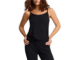 A woman stands with her hands on her hips wearing a Commando Butter Cami in black with adjustable straps and matching black pants.