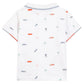 The white short-sleeve shirt from Tartine et Chocolat, called Baby Boys' and Boys' Spicy Orange Polo, reflects Miami's sunny spirit with vibrant back prints of cars, palm trees, and multicolored "TC" letters.