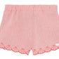 Tartine et Chocolat's Baby Girls' and Girls' Coral Seersucker Shorts feature scalloped embroidery along the hem, delicate embroidered shells, and a small decorative patch on one leg for added charm.