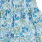 Close-up of a Tartine et Chocolat Girls' Floral Skirt with a blue and green floral Liberty fabric, showcasing gathered and layered details ideal for a breezy summer look.