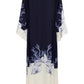 The Lena Kaftan by Carolina K is a long, loose robe with wide sleeves, featuring a navy top and ivory bottom with blue coral and seashell patterns at the hem and cuffs.