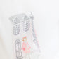 The Girls' Long-Sleeved Graphic T-Shirt by Tartine et Chocolat features a Parisian-inspired illustration of a girl in pink before a towered building, on soft ecru fabric, designed especially for junior girls.