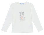 The Tartine et Chocolat Girls' Long-Sleeved Graphic T-Shirt features an ecru design with a Parisian-style illustration of a person walking by a building on the chest.
