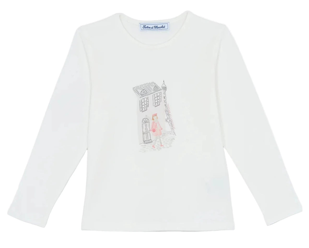 The Tartine et Chocolat Girls' Long-Sleeved Graphic T-Shirt features an ecru design with a Parisian-style illustration of a person walking by a building on the chest.