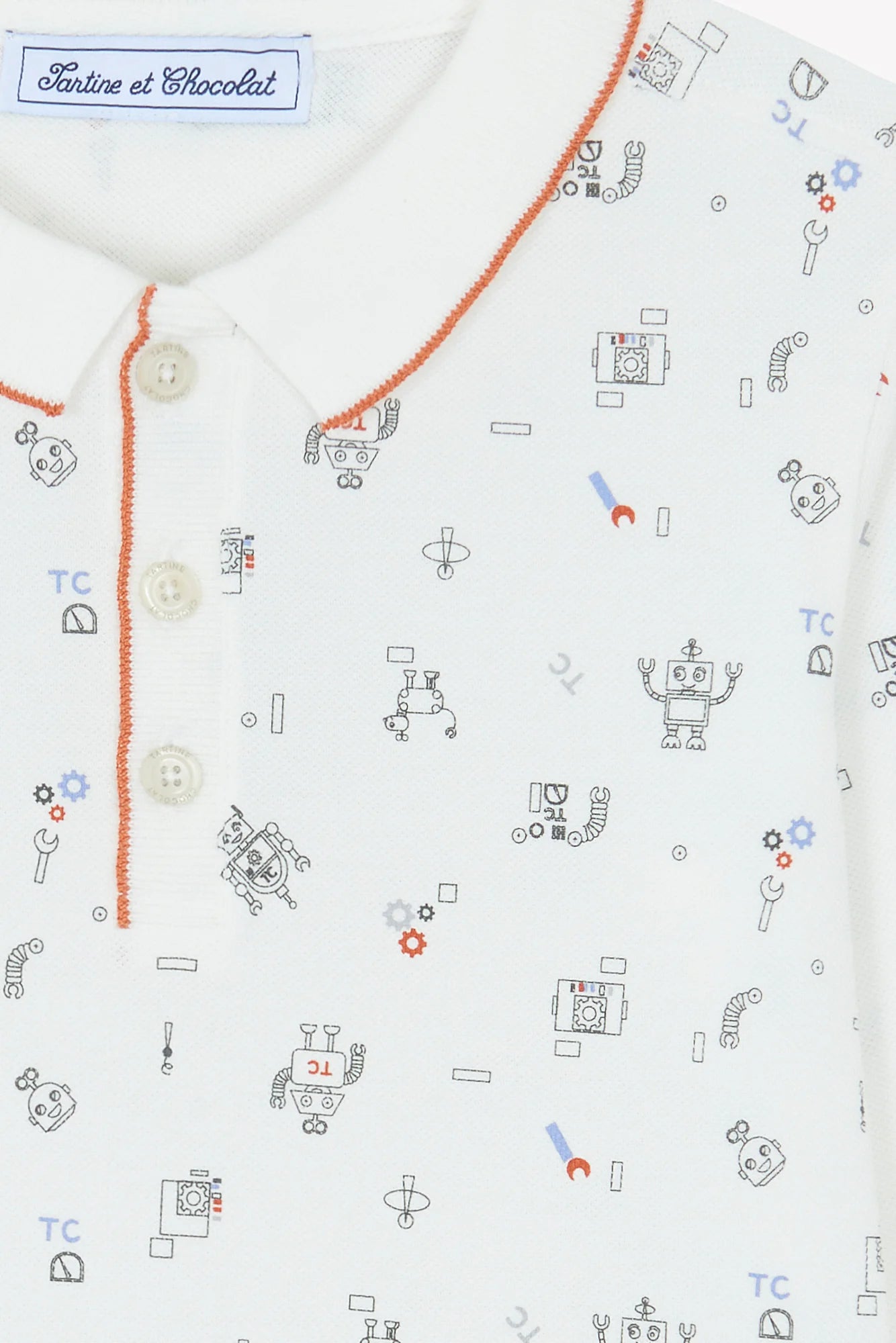 Close-up of Tartine et Chocolat's Baby Boys' and Boys' Robots Illustration Long Sleeved Polo, showing orange trim and a playful robot pattern in blue, red, and gray.