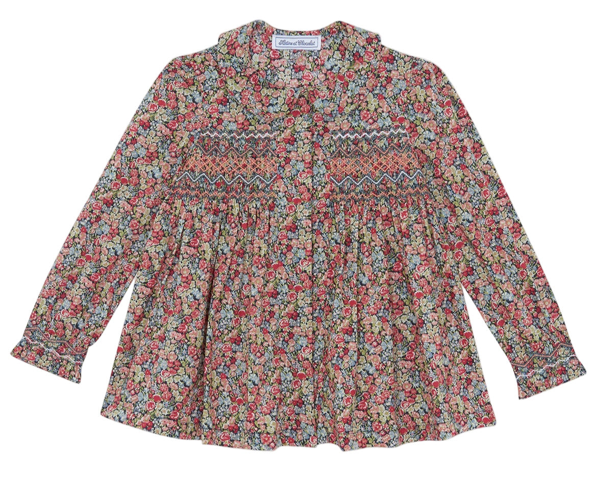 The Tartine et Chocolat Girls' Liberty Smocked Floral Tunic features long sleeves, a vibrant all-over Liberty floral print, and smocked detailing on the chest and upper arms.