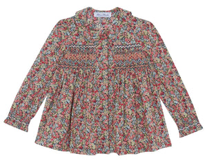 The Tartine et Chocolat Girls' Liberty Smocked Floral Tunic features long sleeves, a vibrant all-over Liberty floral print, and smocked detailing on the chest and upper arms.